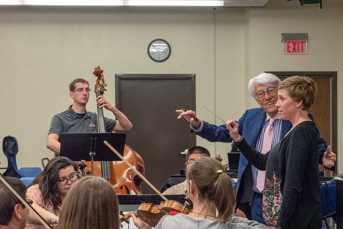 Larry Livingston demonstrating how to conduct properly with a music educator.