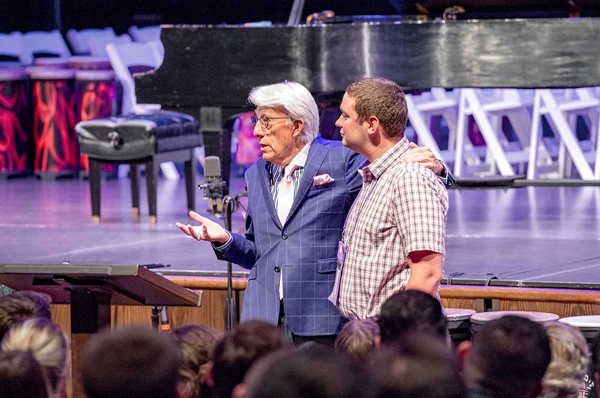 Larry Livingston with a guest from the audience during his live keynote speech.